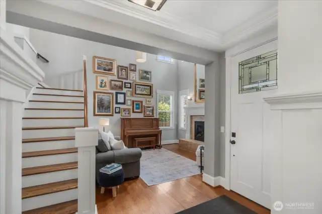Living room features hardwood floors and large windows for natural light.