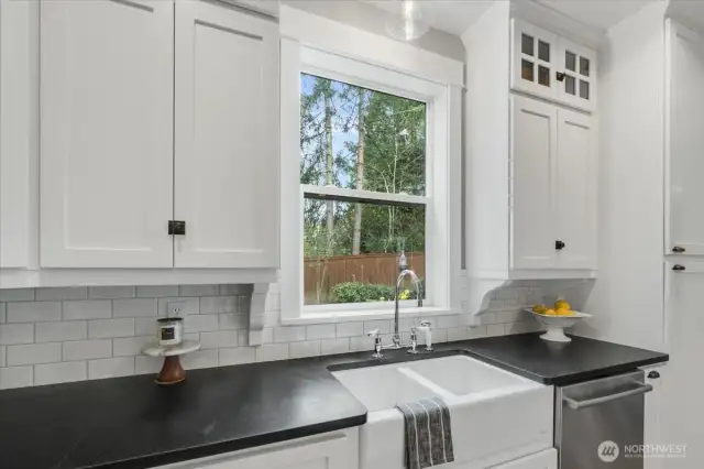 Kitchen features farmhouse sink.
