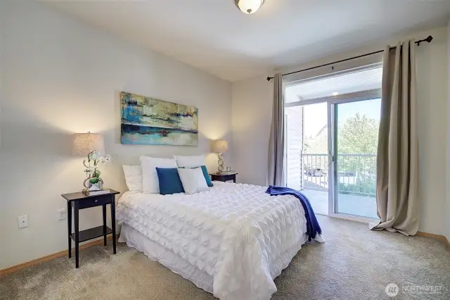 Primary bedroom with slider out to private balcony.