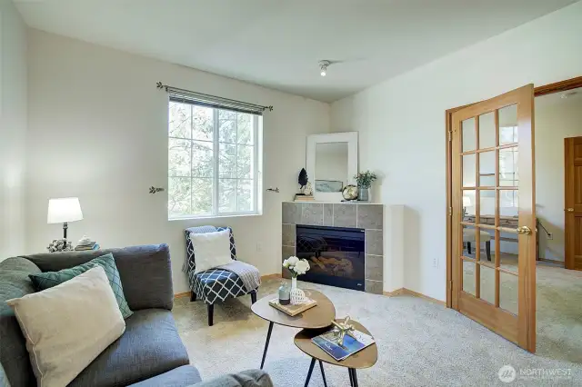 Just off the living room through french doors is a den/office .