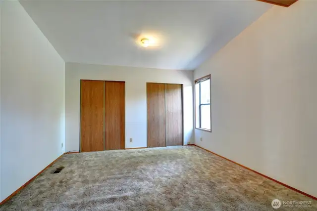 Primary bedroom with wall to wall closets.