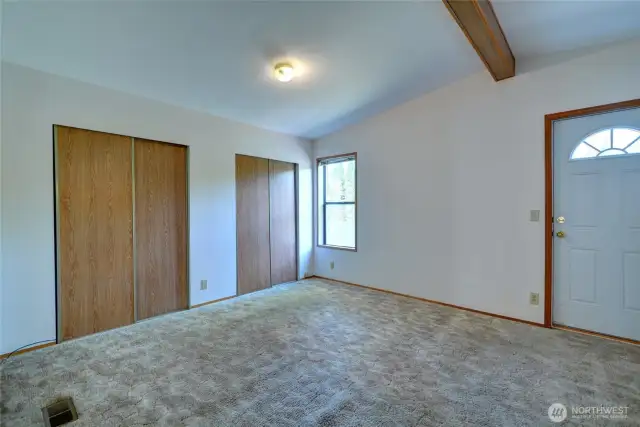 Primary bedroom with exterior door leading to patio and backyard.