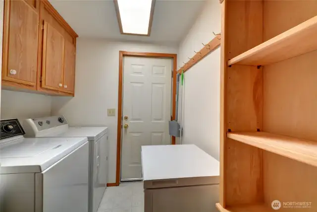 Utility room with Washer and Dryer that stay and separate exterior access.
