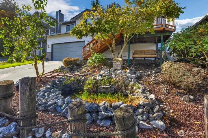 Front yard with pond and bench