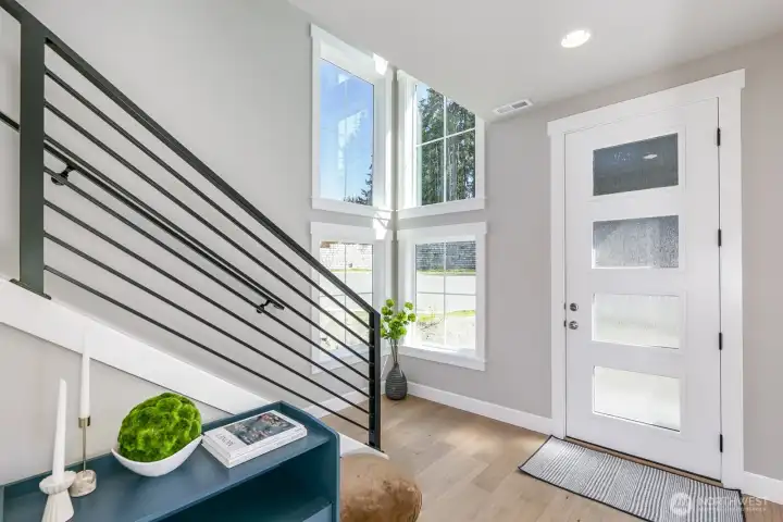 Light filled and modern foyer is inviting to all that enter.