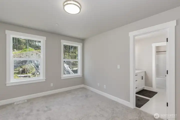 Spacious bedroom with a private door to a shared Jack n' Jill bathroom.