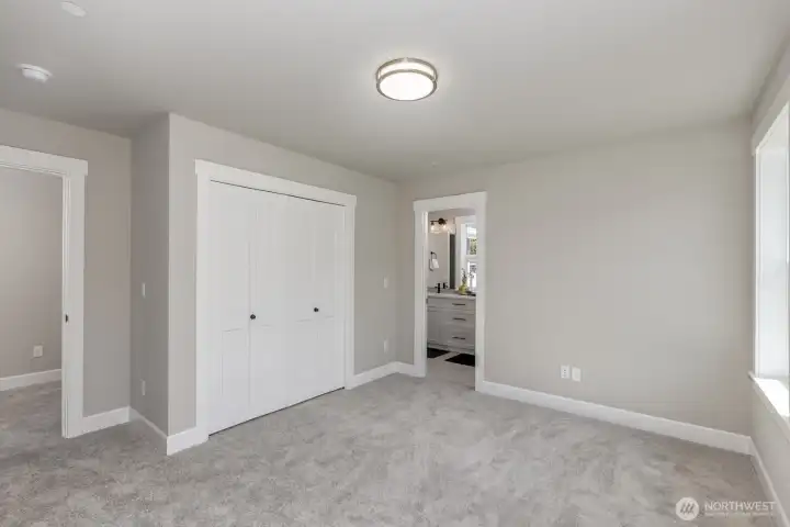 Spacious bedroom with a private door to a shared Jack n' Jill bathroom.