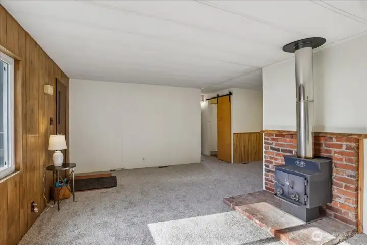 Cozy living room with wood burning stove and new carpet