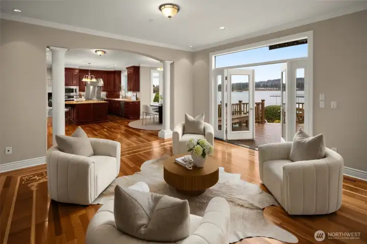 Living spaces flow seamlessly toward the kitchen and waterfront deck.