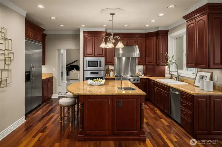 Kitchen centered around a large island designed to flow easily into the surrounding living spaces.