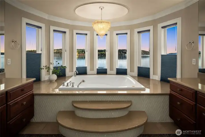 Spa-like jetted soaking tub surrounded by windows and Lake views.