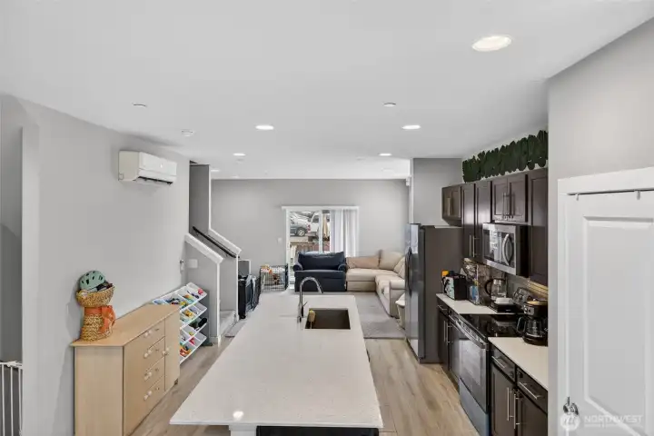 Bright and airy hallway leading to bedrooms, with recessed lighting and clean modern design
