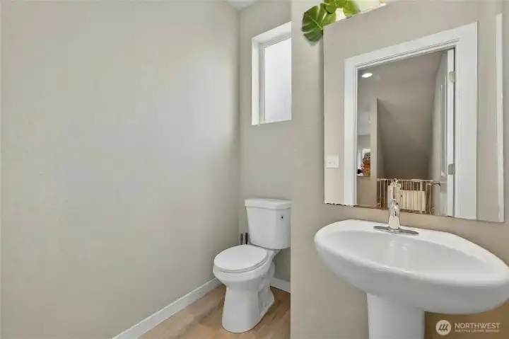 Clean and bright full bathroom with modern fixtures, toilet, and pedestal sink