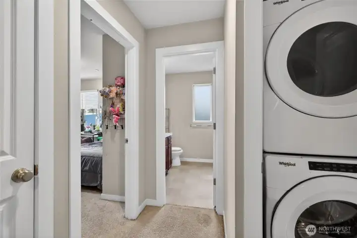 3rd floor laundry area with full-size stacked washer and dryer, conveniently located on the bedroom level