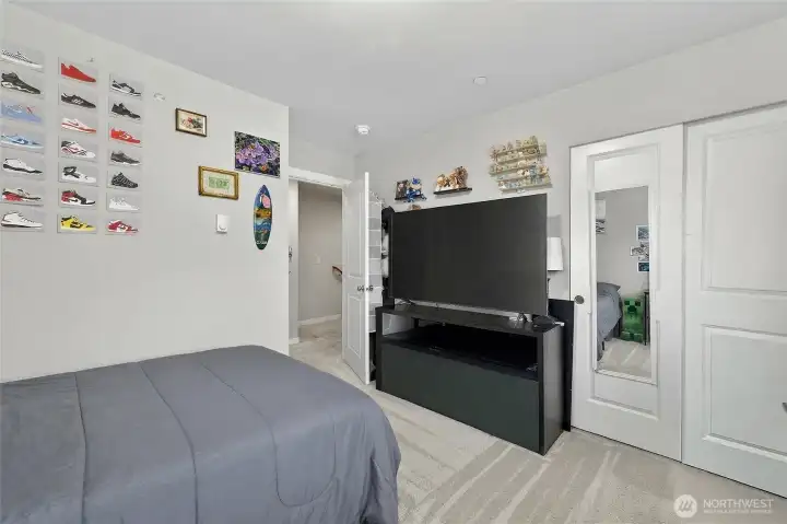 Sun-filled 3rd floor bedroom with large windows and a peaceful, retreat-like atmosphere