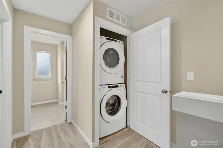 Convenient in-unit laundry closet with stacked washer and dryer for everyday ease