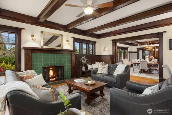 Intimate yet expansive, the main living area showcases built-in seating, artisan woodwork, and period lighting, flowing effortlessly into the formal dining room—an ideal setting for gatherings that feel both refined and warmly personal.