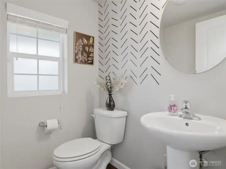 A conveniently located half bath sits just off the front entry, thoughtfully tucked away from the main downstairs living space.
