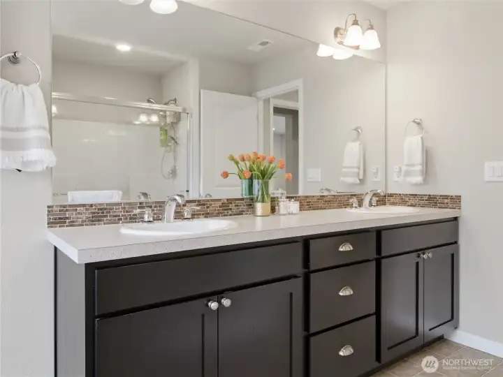 Primary bathroom with double vanity, separate shower and tub.
