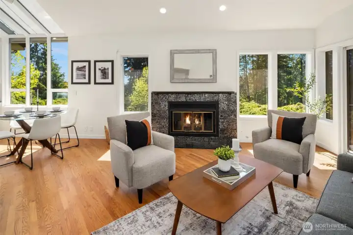 Light-filled family room offers gas fireplace and opens to outdoor deck