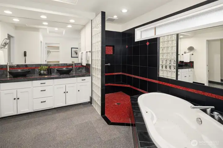 Remodeled primary bath offers dual vanity, soaking tub and large shower