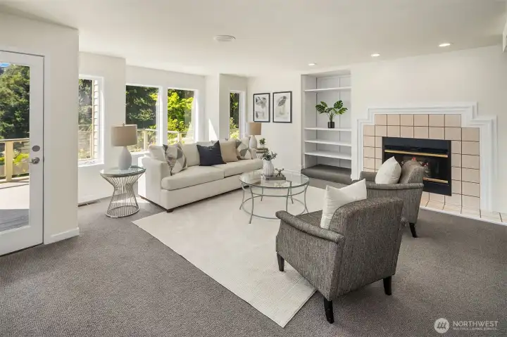 Light-filled rec room with gas fireplace and access to deck and the outdoors