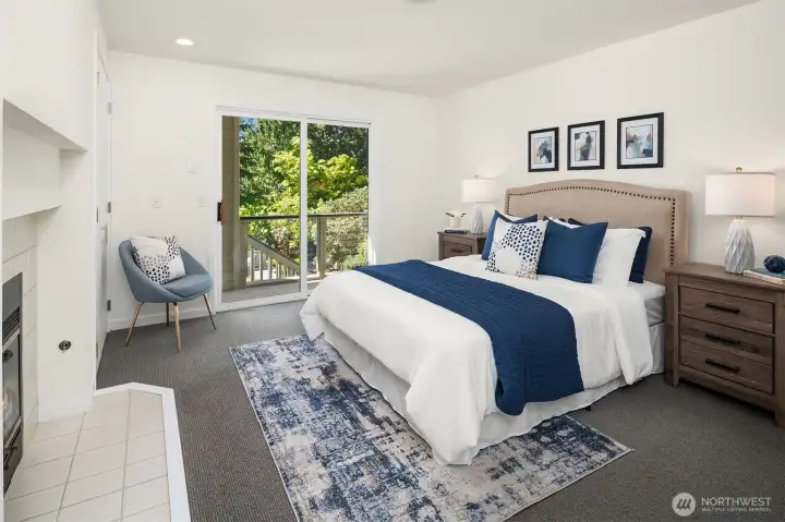 Guest bedroom with fireplace and slider to deck