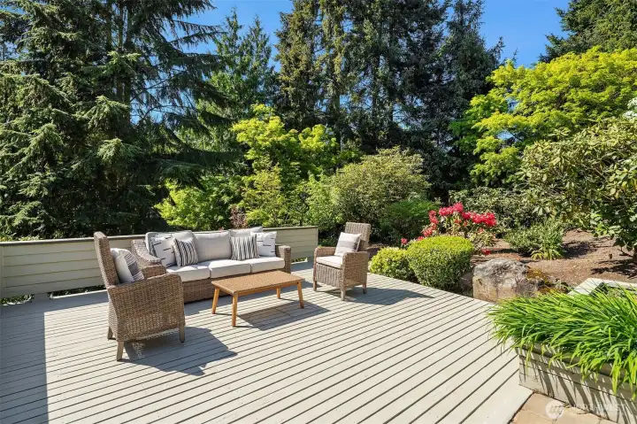 Spacious deck surrounded by beautiful landscaping