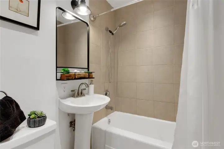 Full Bath on main floor has tile floors, new toilet, and tile Tub Surround.