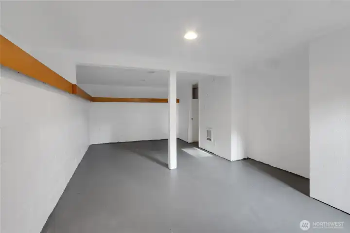 This is the main part of the basement. Painted and clean. So many possibilities. Gym, play area, storage, theater?? Immediately to the right is the large 1/2 bath, the door ahead on the right goes into another room.