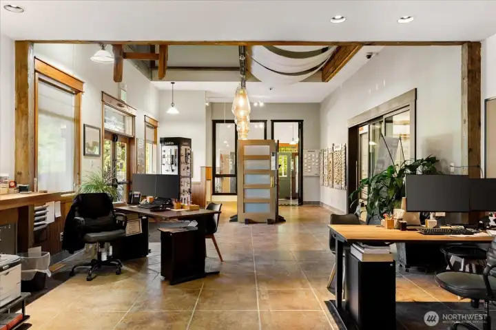 This is a SE view of the front double door entry to the showroom areas at the SE part of the main floor.  Note the extra volume of space above the entry area.