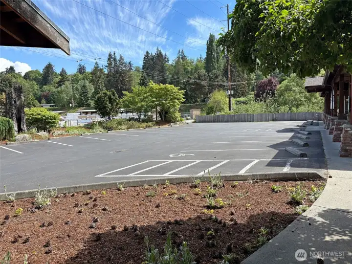 Nearly the full view of the parking lot, 21 spaces + bike rack.