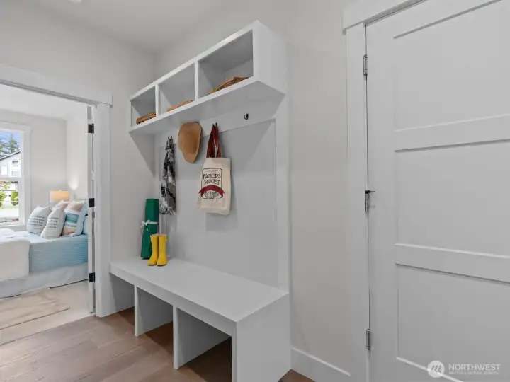 Convenient mudroom positioned just off the garage, providing the perfect drop zone for everyday life. Features a custom built-in bench with hooks for coats, upper and lower cubbies to neatly tuck away bags and shoes, and ample counter space to easily set down groceries or packages as you arrive home. Virtually staged. Convenient mudroom positioned just off the garage, providing the perfect drop zone for everyday life. Features a custom built-in bench with hooks for coats, upper and lower cubbies to neatly tuck away bags and shoes, and ample counter space to easily set down groceries or packages as you arrive home. Virtually staged.