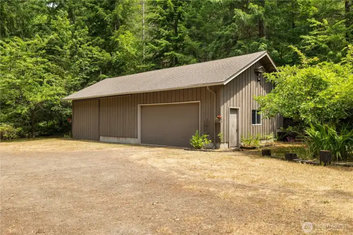 Shop with sliding barn door on the left and traditional garage door on the  right.
