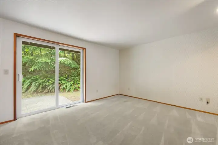 Primary room with sliding doors to back patio for a peaceful retreat.