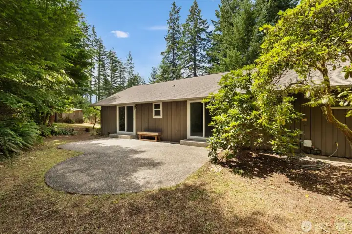 Backyard of property with patio for relaxing and BBQ's.