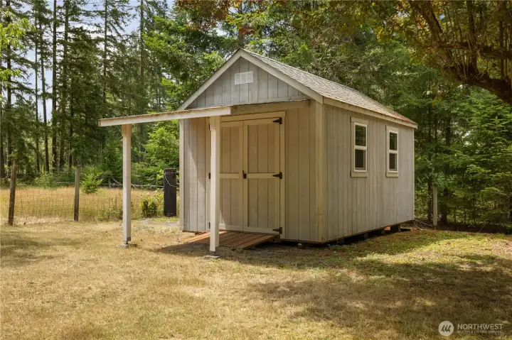 Newer shed for lawn equipment and storage.