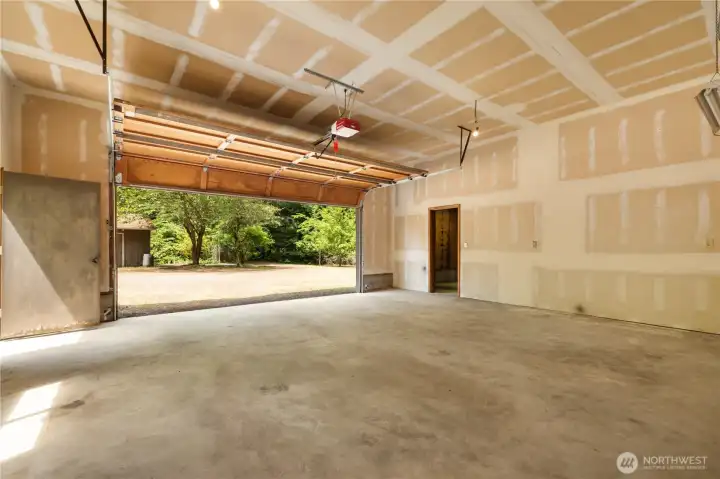 Right side of garage/shop with space for 2 cars, and still room for more storage or workspace.