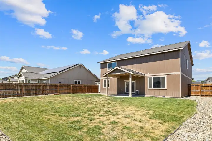 Fenced back yard with sprinklers