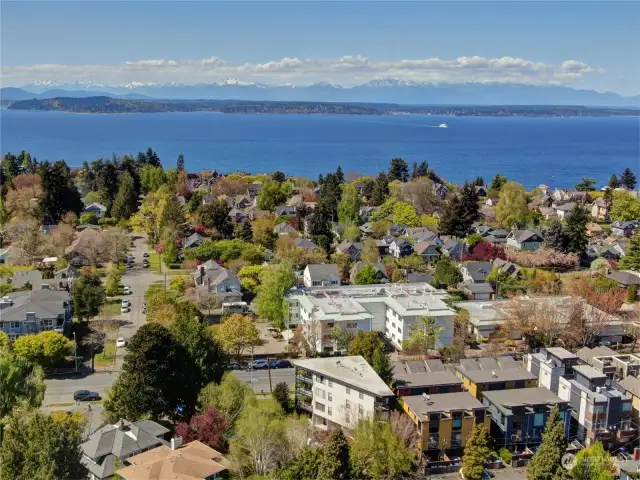 West-facing aerial view of the dazzling Olympic Mountains, with the triangular building in the foreground.