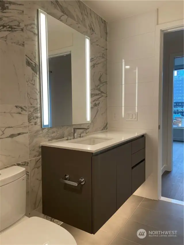 Under vanity lighting and medicine cabinet with power inside.