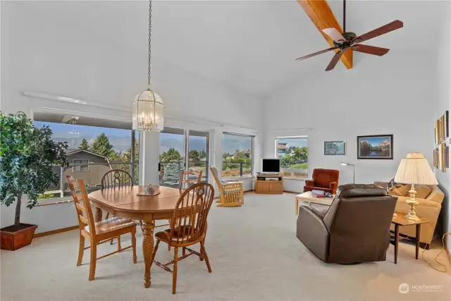 Spacious great room with vaulted ceiling and a wall of windows to capture views