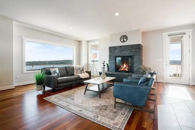 Beautiful Brazilian Cherry floors add  a richness to this great room. Large windows help you position your furniture to take full advantage of the beauty beyond.