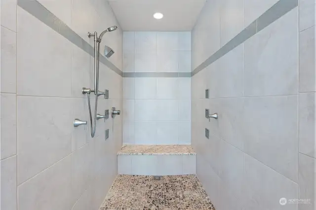 Large zero threshold shower beckons you to wash the day's cares away. The multiple shower jets, pebbled floor and relaxing bench make this shower the place to go to after a long day.