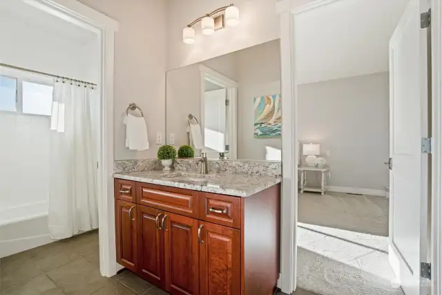 The lower level full bathroom conveniently sits between both lower level bedrooms. A separate water closet with a sink can be closed off from the shower area for privacy.