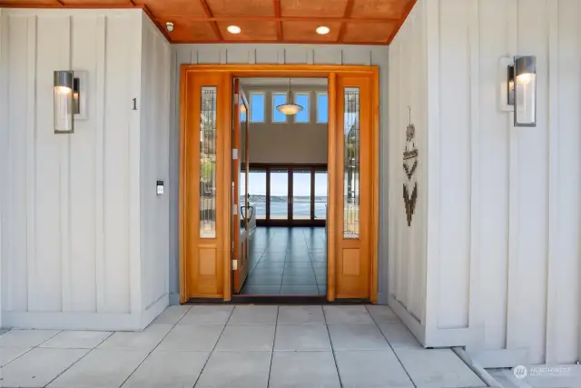 A dramatic design awaits behind the custom glass entry door. Breathtaking views will draw you in through the open foyer and straight out to the water.