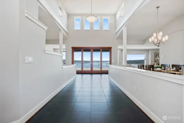 As soon as you enter you'll be awed and inspired. Double glass doors draw you to the deck, and the amazing views wait beyond them. The high ceilings and multiple transom windows allow for all of the natural light to flow in from every angle.