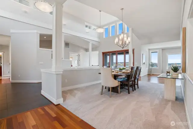 The bright, formal dining room is perfect to share a meal with friends. The open concept makes it the perfect setting for mingling before the meal is served.