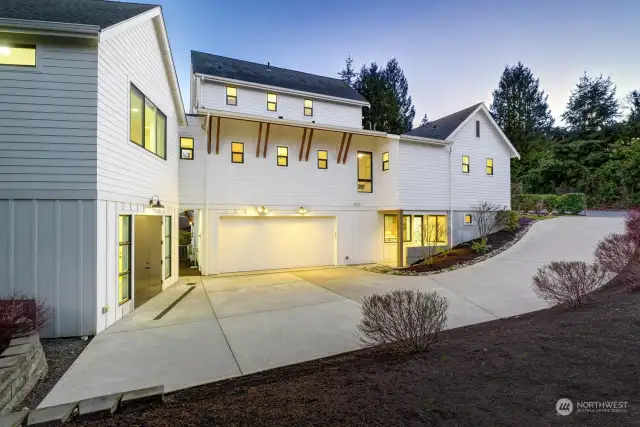 view of home from the north; ADU front door to the right of garage doors