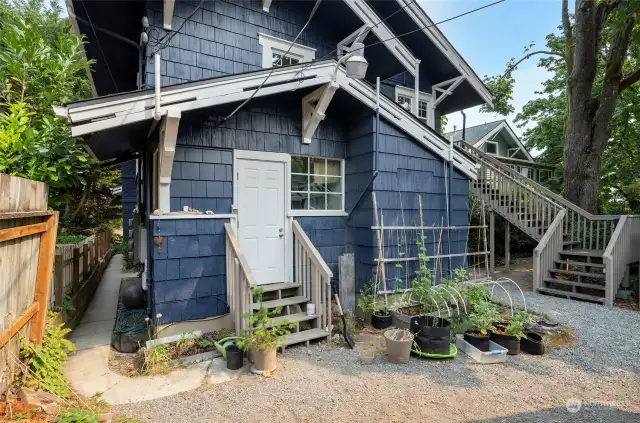 The back of the house offers privacy, and a communal garden/courtyard area. The back of the house also offers an entrance to the utility room for Unit 2.